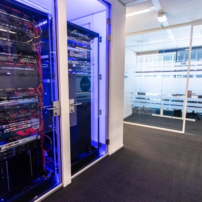 Modern office space with a server room and a glass-walled meeting area at Kampenringweg 45, Gouda, available for rent. Office space rental features a high-tech setup.