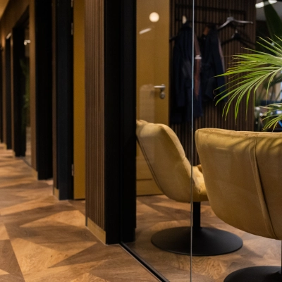 Modern office space to rent at Zuidelijk Halfrond 1, Gouda, showing a hallway with stylish chairs and potted plants, ideal for office space rental.