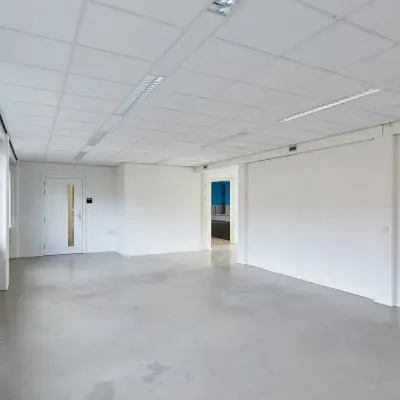 Spacious and bright office space for rent at Schweitzerlaan 12, Groningen, featuring plain walls and ceiling lights, ideal for customization.