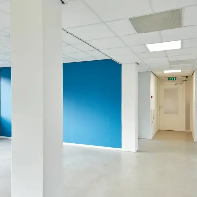 Interior of an unfurnished office space with blue accent wall at Schweitzerlaan 12, Groningen, available for office space rental.