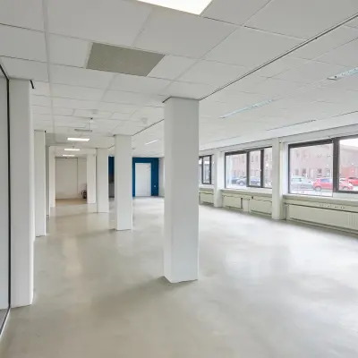 Spacious office space available for rent at Schweitzerlaan 12, Groningen, featuring large windows and an open floor plan for optimal workspace layout.