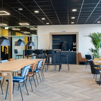 Modern office space at Zernikepark 12, Groningen, featuring stylish seating and a coffee station, ideal for office space rental.