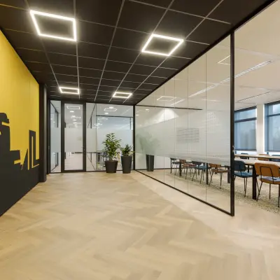 Modern office space at Zernikepark 12, Groningen featuring a glass-walled conference room for office space rental.