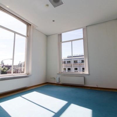 Bright, unfurnished office space with large windows for rent at Prinsen Bolwerk 1, near Haarlem Centraal Station.