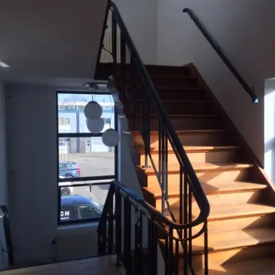 Interior view of a staircase with wooden steps and railings, located at Nijverheidsweg 50 in Haarlem Oost, nearby office space rental options.