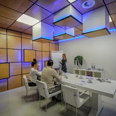 A modern conference room at A. Hofmanweg 5A in Haarlem Waarderpolder, featuring people engaged in a meeting. Ideal office space rental for dynamic teams.