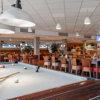 Spacious, vibrant office space available for rent at A. Hofmanweg 5A in Haarlem Waarderpolder, featuring a pool table and dining area.