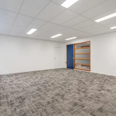 Bright, unfurnished office space with carpet flooring and modern lighting at A. Hofmanweg 5A, ideal for individuals seeking office space rental in Haarlem Waarderpolder.