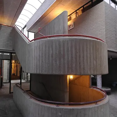 Interior view showcasing a unique concrete staircase with open lighting at an office to rent in Hilversum.