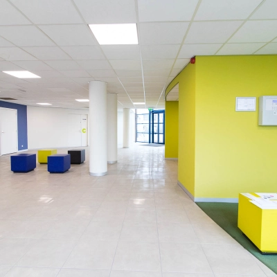 Spacious and bright entrance area at Franciscusweg 219 in Hilversum with colorful seating, ideal for office space rental.