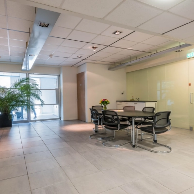 Bright office space at Mozartlaan 27, Hilversum, with modern furnishings and a meeting table. Ideal for office space rental.