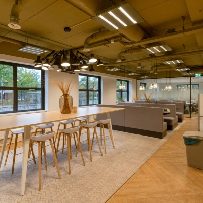 Bright, furnished office space at Olympia 1, Hilversum, with modern seating, ambient lighting, and large windows, ideal for office space rental.