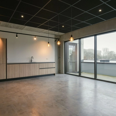 Modern office space at Zuiderloswal 55, Hilversum featuring large windows and a minimalist kitchenette, perfect for office space rental.