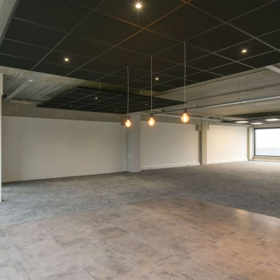 Wide open office space available for rent in Hilversum at Zuiderloswal 55, featuring large windows and modern lighting, ideal for customization.