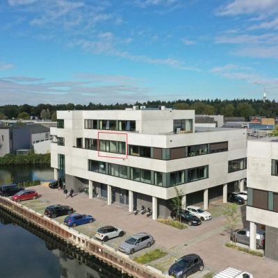 Exterior view of an office building at Zuiderloswal 55, Hilversum, showcasing potential office space rental opportunities by the waterfront.