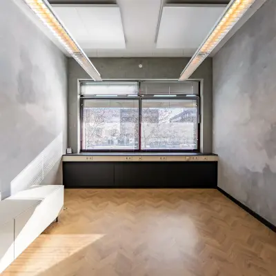 Unfurnished office space rental at Opaallaan 1180, Hoofddorp, featuring large windows and wooden flooring, ideal for a fresh start.