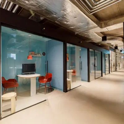 Furnished office space rental with modern workspaces featuring glass-enclosed units at Siriusdreef 16, Hoofddorp.