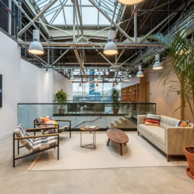 Modern office lounge with stylish furniture, plants, and natural light at Siriusdreef 17, ideal for office space rental in Hoofddorp.