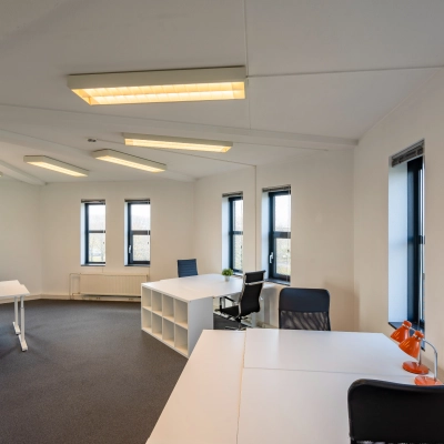 Bright office space with large windows and modern furnishings at Hoofdveste 2, Houten, ideal for office space rental.