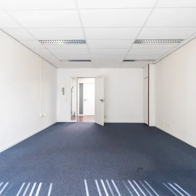 Unfurnished office space available for rent at Sandtlaan 36, Katwijk, featuring ample natural light and a spacious layout.