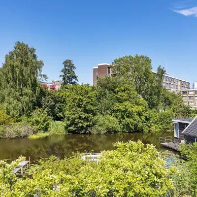View from an office revealing serene greenery and a waterway, ideal for a calm work environment at Ouddeelstraat 7a, Leeuwarden.