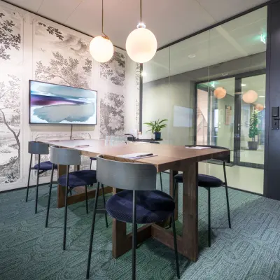 Stylish conference room at Bargelaan 200 in Leiden, available for office space rental, featuring a wooden table, modern chairs, and ambient lighting.