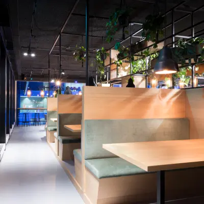 Modern office space with cozy wooden booths and greenery at Bargelaan 200 in Leiden, perfect for rent office space seeking a vibrant environment.