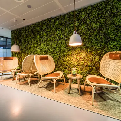 Modern office area at Bargelaan 200, Leiden, featuring stylish seating against a lush green wall, ideal for rent office space seekers.