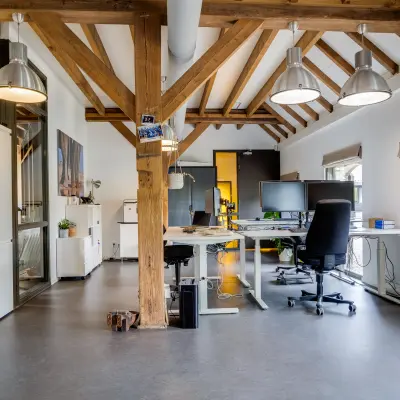 Spacious office space at Hamersveldseweg 120, Leusden, featuring modern desks and exposed wooden beams, available for rent. Ideal for office space rental.