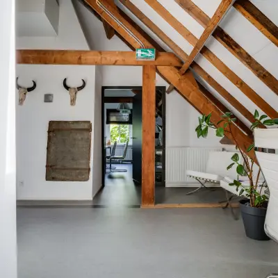 Cozy office to rent at Hamersveldseweg 120, Leusden, featuring a furnished workspace with wooden beams and modern chairs, ideal for office space rental.