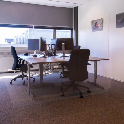 Bright office space with desks and chairs, available for rent at Brieltjenspolder 28, in Made. Ideal for office space rental needs with a cozy setup.