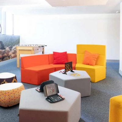 Colorful, modern office space at Calle de la Caléndula 93 in Madrid Alcobendas, featuring vibrant seating and a foosball table, ideal for rent office space or office space rental.