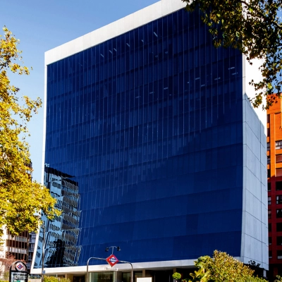 Modern office building with blue glass facade located on Paseo de la Castellana 141 in Madrid Azca, ideal for office space rental.