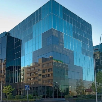 Modern glass office building located at Avenida del Partenón 16-18, Madrid Barajas, available for rent as office space.
