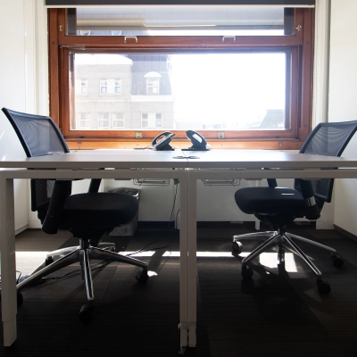 Bright office to rent at Paseo de Recoletos 5, Madrid Recoletos, featuring two chairs and a desk under a large window.