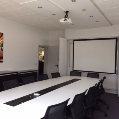 Modern conference room with long table and chairs available for office space rental in Mechelen North.