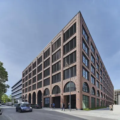 Exterior view of an office building at Mühldorfstraße 8, München Werksviertel, suitable for office space rental, showcasing a modern brick design.