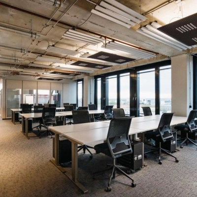 Spacious office space with modern furnishings and large windows at Rosenheimer Straße 143C, München Werksviertel, ideal for professionals seeking office space rental with ample natural light and ergonomic seating.