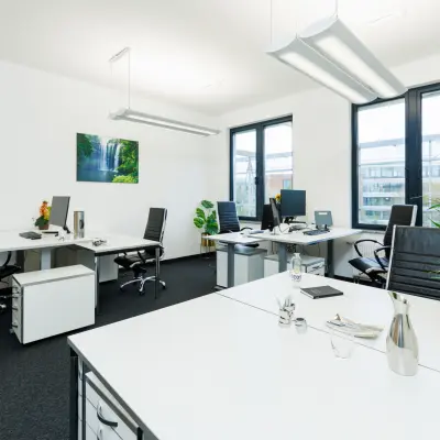 Bright office space at Landsberger Straße 155, Munich Laim, featuring multiple workstations with chairs and plants, ideal for rental.