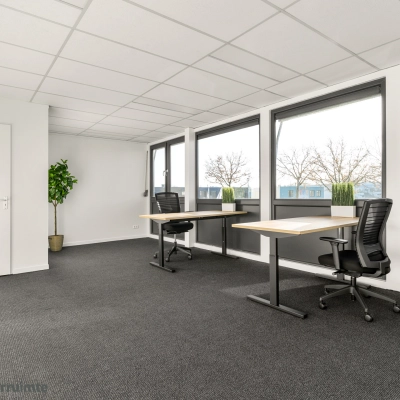 Bright and empty office space with large windows and two desks, available for office space rental at Nijverheidsweg 9B, Nieuwegein.