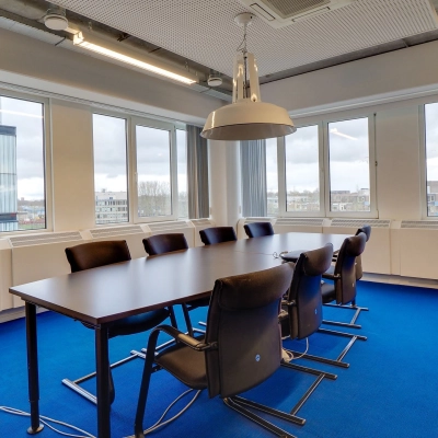 Spacious conference room at Zoomstede 19, Nieuwegein, featuring a large table, chairs, and ample natural light, ideal for office space rental.