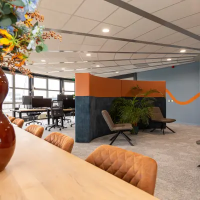 Interior view of furnished office space at Patroonstraat 13, Nijkerk, featuring modern chairs, tables, and vibrant decor ideal for office space rental.