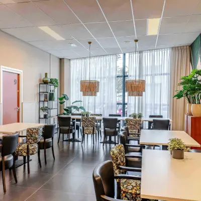 Interior of a furnished lounge area with tables and chairs at Leeghwaterstraat 25, ideal for office space rental.