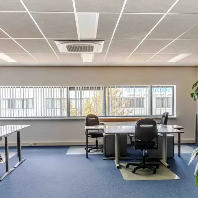 Spacious, brightly lit office with multiple desks and chairs available for rent at Leeghwaterstraat 25, Reeuwijk. Ideal for office space rental.