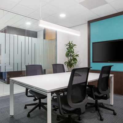 Modern furnished conference room at Einsteinlaan 28, Rijswijk, featuring a sleek table, comfortable chairs, and a wall-mounted screen, suitable for office space rental.