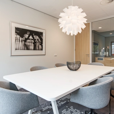 Furnished conference room at Laan van Vredenoord 33, Rijswijk, featuring a modern table and chairs, suitable for office space rental.