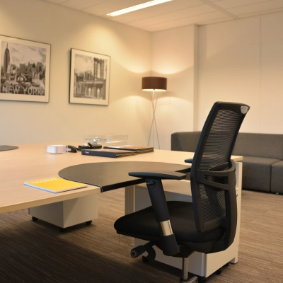 Interior of a furnished office at Laan van Vredenoord 33, Rijswijk, featuring a desk, a chair, and a comfortable sofa. Ideal for office space rental with modern amenities.