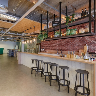 Furnished office space at Patrijsweg 62, Rijswijk, featuring a modern lounge area with a long counter and bar stools, exposed ceilings, and decorative lighting.