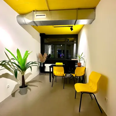 Bright office space at Volmerlaan 7 in Rijswijk featuring yellow chairs and plants, ideal for a vibrant workspace. Consider this office space rental for a fresh and modern business environment.