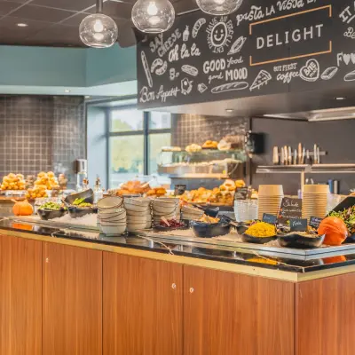 Inviting office pantry area with a buffet of food items, pumpkins, and decorative elements, ideal for a comfortable workspace experience.